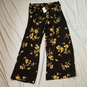 Torrid: Black and yellow floral pants.
